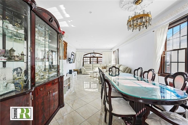 dining space with an inviting chandelier, ornamental molding, and light tile patterned flooring