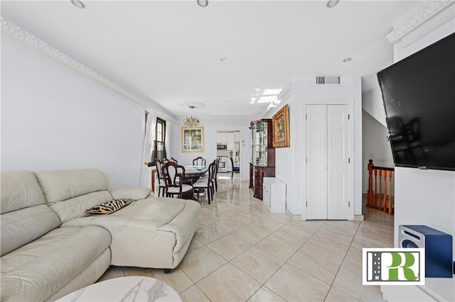 living area featuring visible vents, crown molding, and light tile patterned flooring