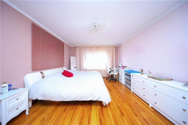 bedroom featuring ornamental molding and light wood finished floors