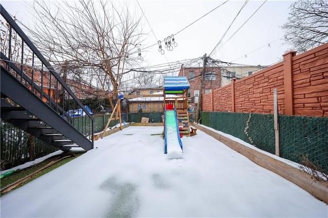 exterior space with fence and a playground