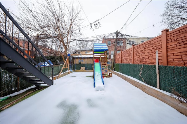 view of patio / terrace with a playground, stairs, and fence