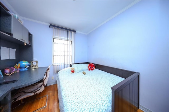 bedroom featuring wood finished floors, ornamental molding, and baseboards
