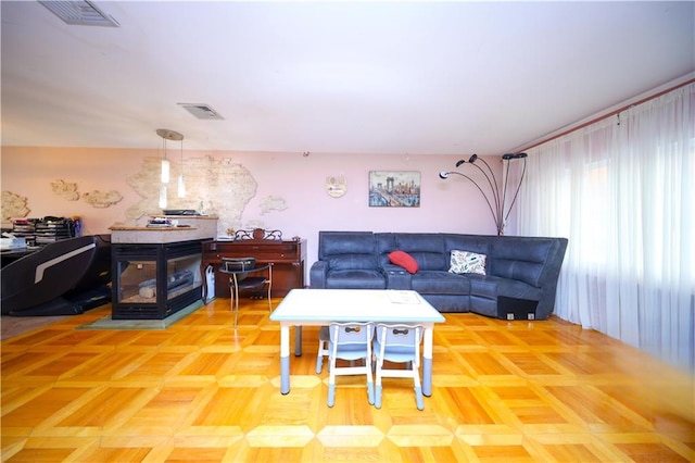 living area featuring a wood stove and visible vents