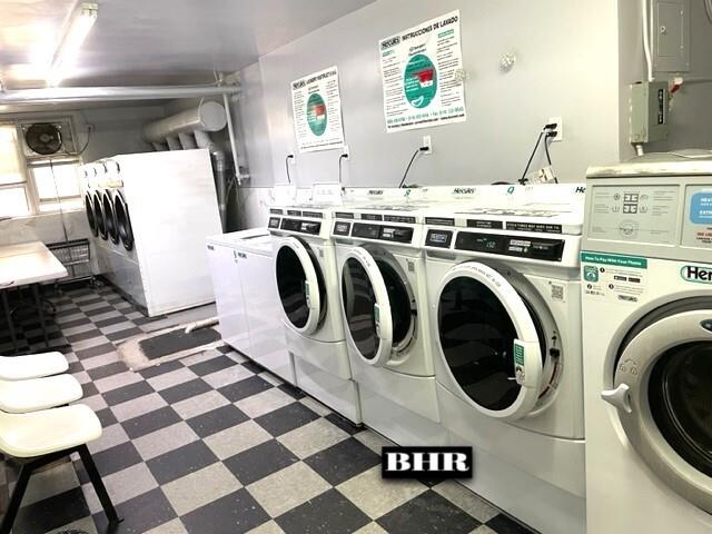 1625 Emmons Ave Unit 6T, Brooklyn, NY 11235 - shared laundry with tile patterned floors, independent washer and dryer, and electric panel