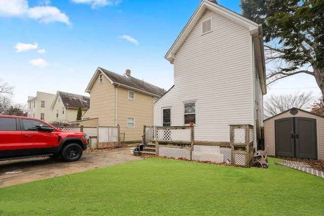 view of home's exterior with an outbuilding, a lawn, a deck, and a storage shed