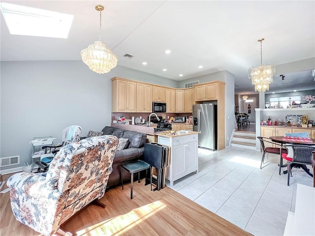 kitchen with light countertops, visible vents, black appliances, and an inviting chandelier