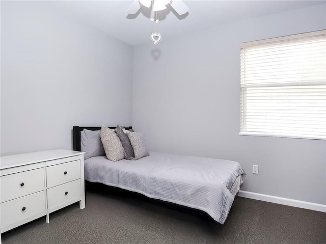 bedroom featuring a ceiling fan, carpet, and baseboards