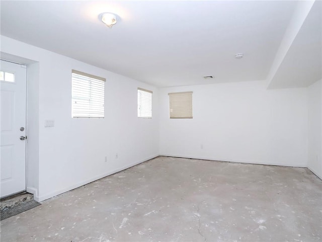 unfurnished room with concrete flooring and visible vents