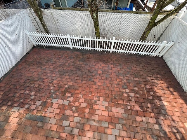 view of patio featuring fence