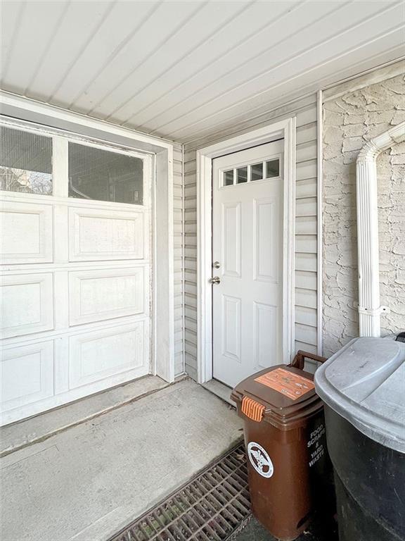 view of exterior entry with a garage