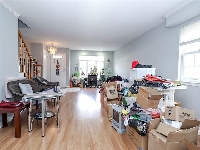 living room featuring light wood-type flooring, stairway, and a wealth of natural light