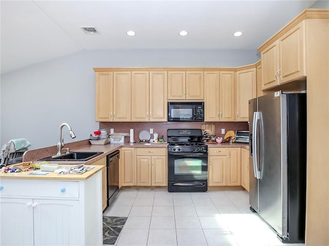 kitchen featuring visible vents, a peninsula, black appliances, light brown cabinets, and a sink