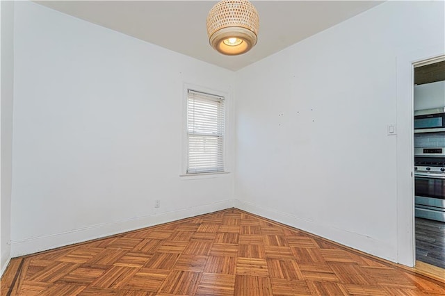 spare room featuring baseboards