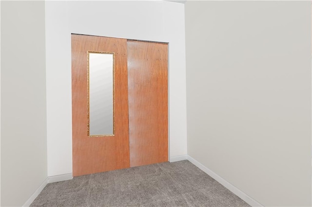 spare room with carpet and baseboards