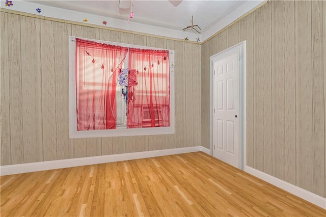 spare room featuring wood finished floors and baseboards