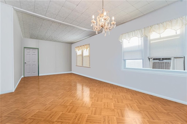 spare room featuring a wealth of natural light, cooling unit, and baseboards