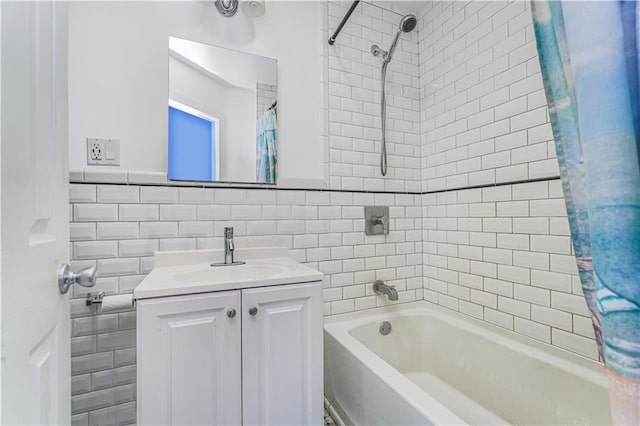 bathroom featuring shower / bathtub combination with curtain, tile walls, and vanity