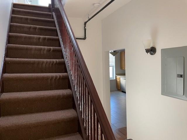 staircase featuring electric panel