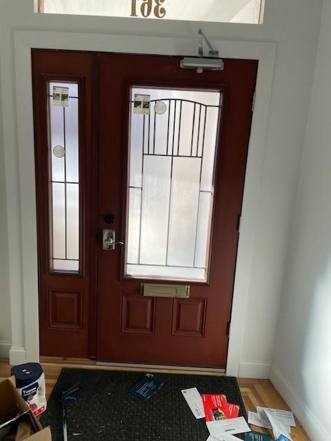 entryway with light wood-style flooring and baseboards