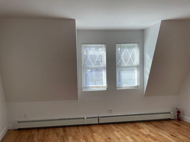 interior details with baseboards, wood finished floors, and baseboard heating