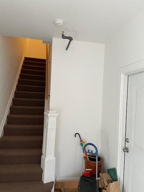staircase featuring baseboards