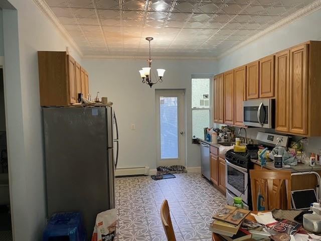 kitchen featuring stainless steel appliances, baseboard heating, an ornate ceiling, and crown molding