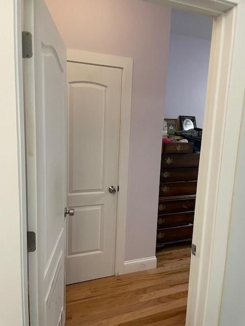 interior space with light wood-style floors and baseboards