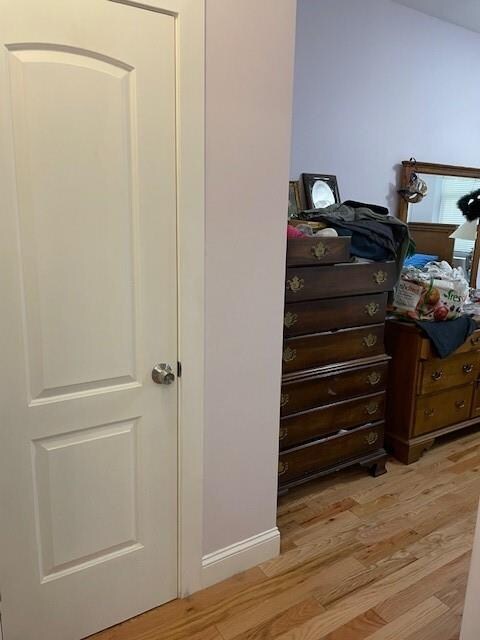 interior space featuring baseboards and wood finished floors