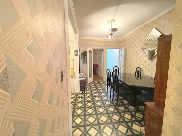 dining area featuring crown molding, baseboards, and wallpapered walls