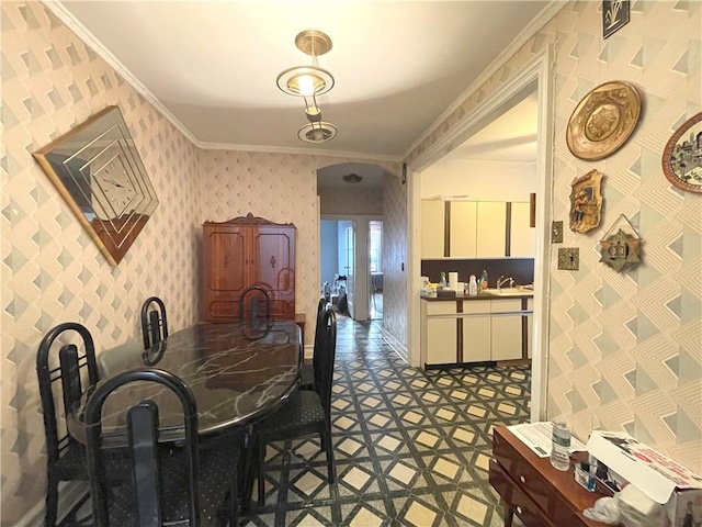 dining room featuring wallpapered walls, baseboards, crown molding, and tile patterned floors