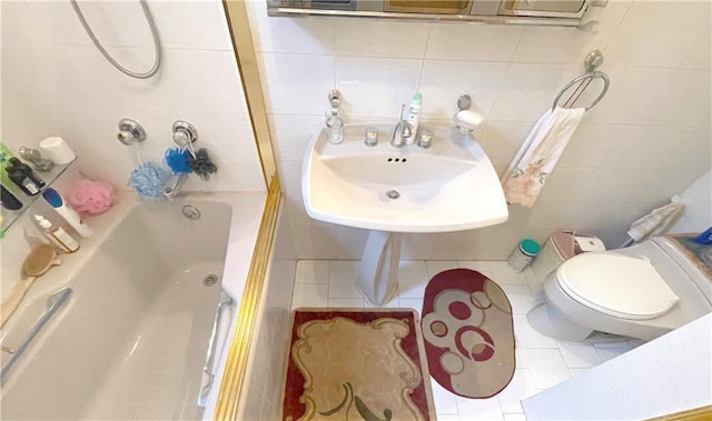 full bathroom with tile walls, toilet, tile patterned flooring, shower / bathtub combination, and a sink