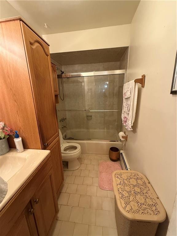 full bathroom featuring baseboard heating, shower / bath combination with glass door, vanity, and toilet