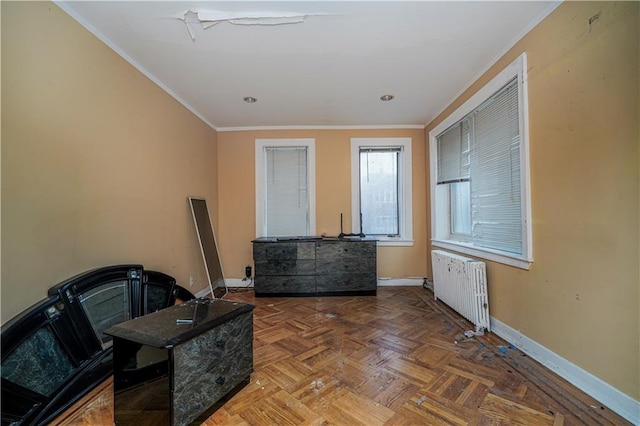 interior space with radiator, baseboards, and crown molding