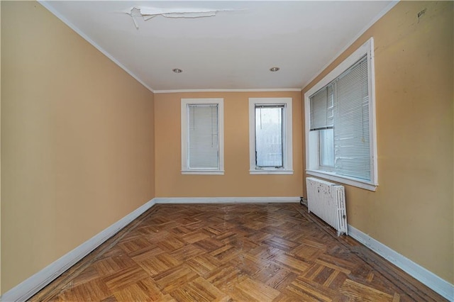 unfurnished room featuring ornamental molding, baseboards, and radiator heating unit