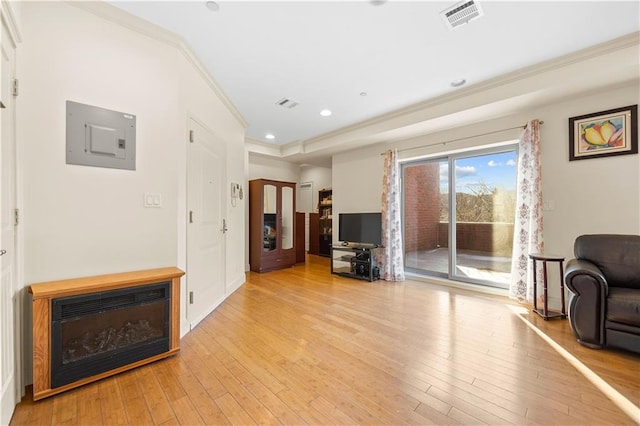 living area featuring recessed lighting, visible vents, light wood-style floors, electric panel, and crown molding