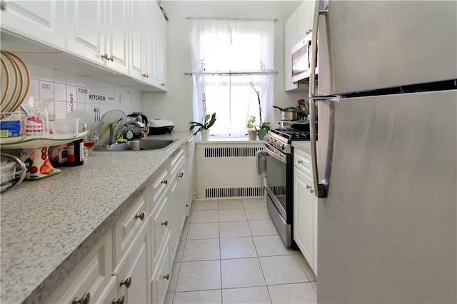 2375 Ocean Ave Unit 3H, Brooklyn, NY 11229 - kitchen with white cabinetry, radiator, appliances with stainless steel finishes, and a sink