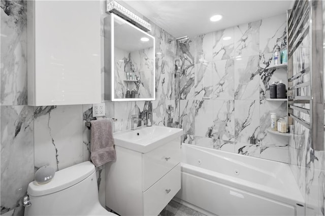 full bath with a combined bath / shower with jetted tub, vanity, toilet, and tile walls