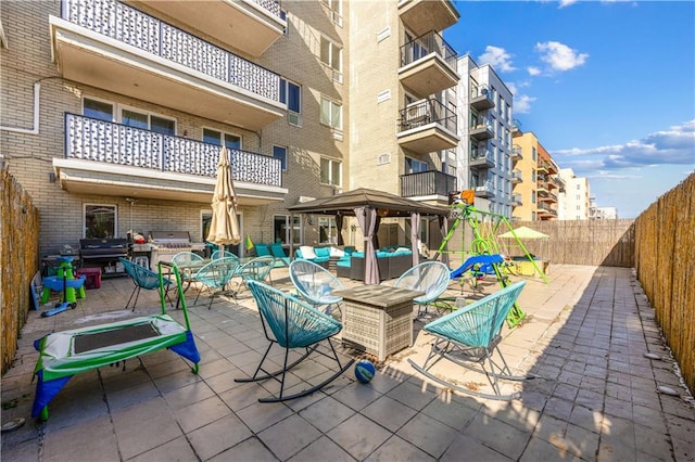 view of patio / terrace with a fenced backyard, an outdoor hangout area, and a gazebo