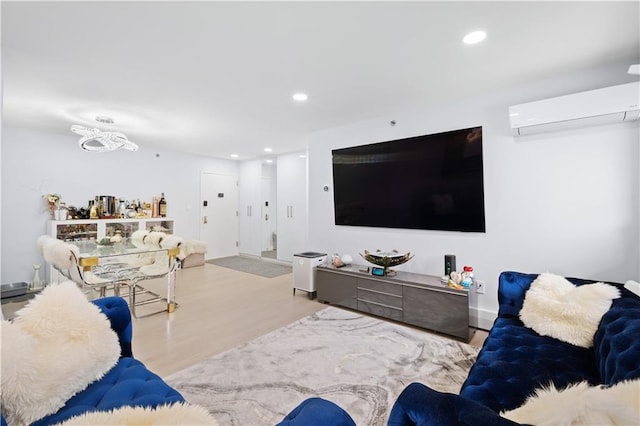 living room with a wall mounted AC, wood finished floors, and recessed lighting