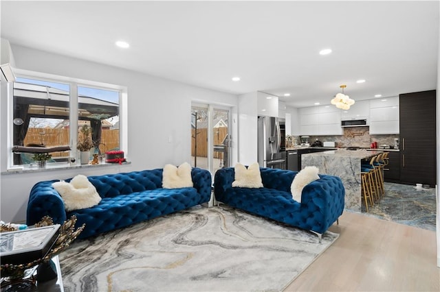 living room with recessed lighting and light wood-style flooring