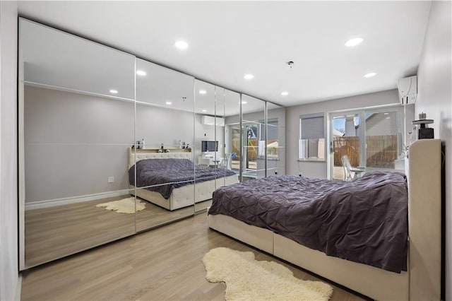 bedroom with recessed lighting, access to outside, baseboards, and wood finished floors