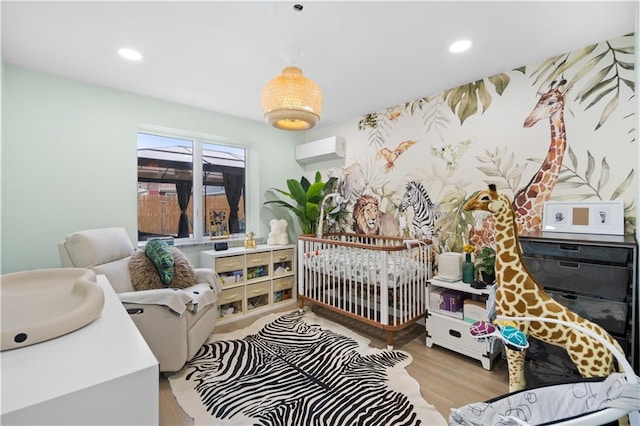 bedroom with a wall mounted AC, wood finished floors, and recessed lighting