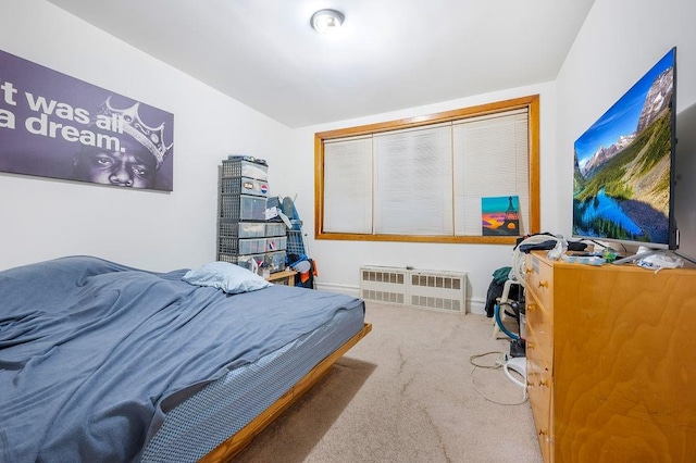 bedroom with radiator, carpet flooring, and baseboards