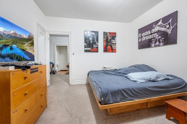 bedroom featuring light carpet