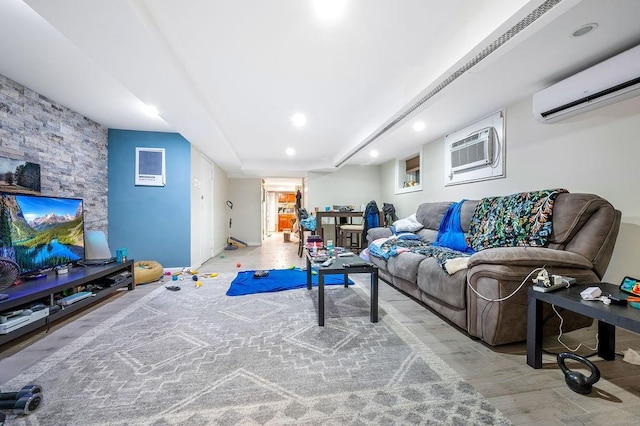 living area featuring a wall unit AC, wood finished floors, and recessed lighting