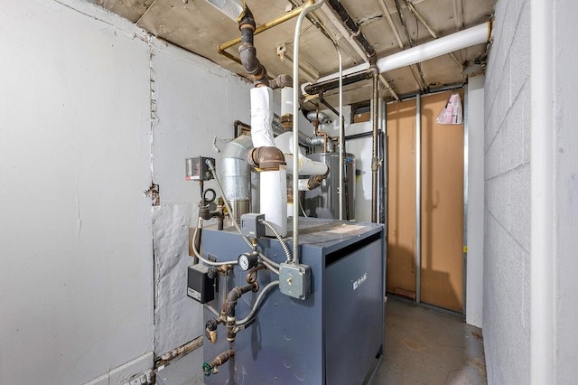 utility room featuring water heater and a heating unit