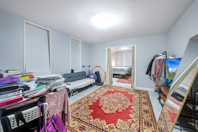 bedroom with wood finished floors and baseboards