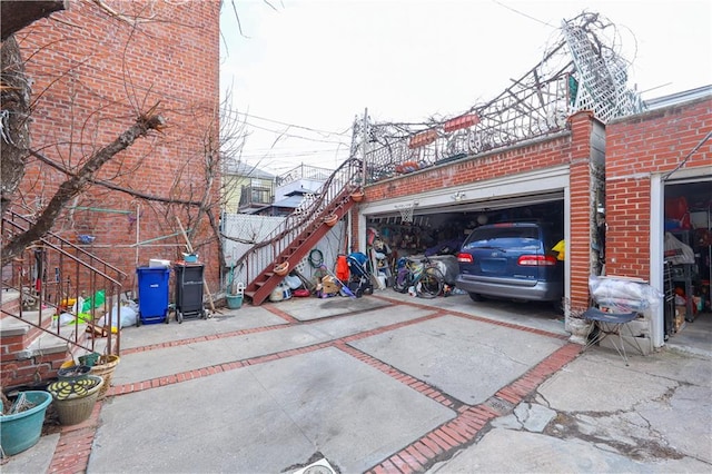 view of parking with a garage and driveway