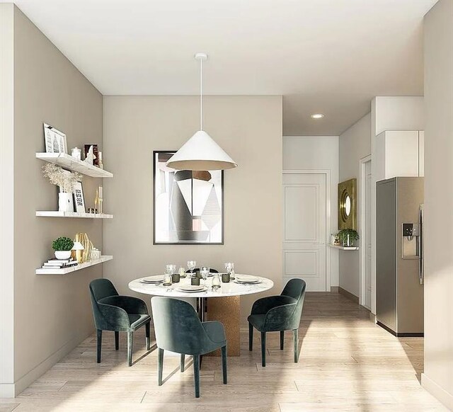 dining area with light wood finished floors and recessed lighting