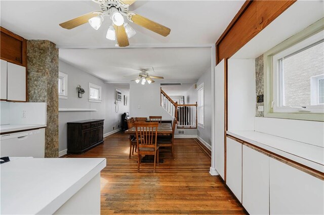 dining space with a ceiling fan, stairs, baseboards, and wood finished floors